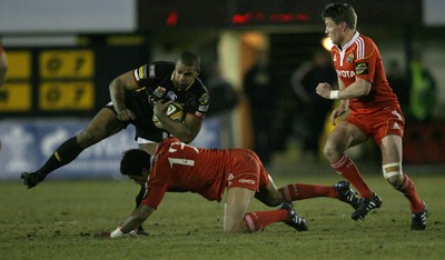 06.02.10 Dragons v Munster... Dragons' Aled Brew  is tackled by Munster's Lifeimi Mafi. 