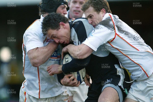 010106Newport Gwent Dragons v Ospreys Ospreys Adrian Cashmore is held by Gareth Chapman and Hal Luscombe  