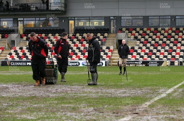 010117 - Newport Gwent Dragons v Ospreys - GuinnessPro12 -  Referee Ian Davies looks on as Ground staff work hard to make the pitch fit to play on by Huw Evans Agency