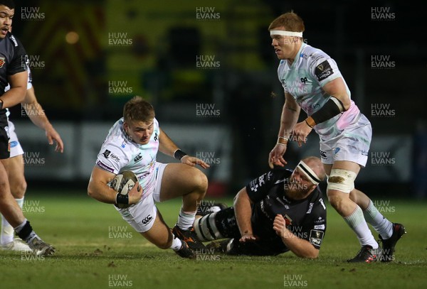 090121 - Dragons v Ospreys - Guinness PRO14 - Ifan Phillips of Ospreys is tackled by Joe Davies of Dragons