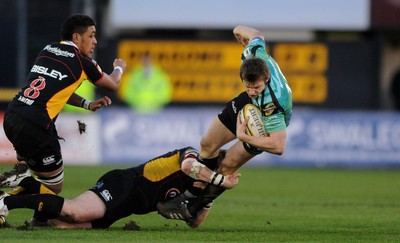 27.03.10 - Newport-Gwent Dragons v Ospreys - Magners League - Dan Biggar of Ospreys is tackled by Hugh Gustafson of Newport-Gwent Dragons. 