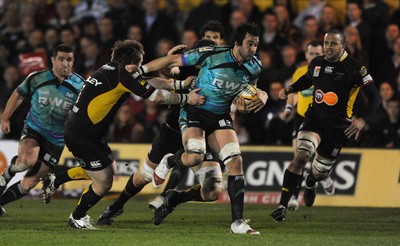 27.03.10 - Newport-Gwent Dragons v Ospreys - Magners League - Jonathan Thomas of Ospreys is tackled by Hugh Gustafson of Newport-Gwent Dragons. 