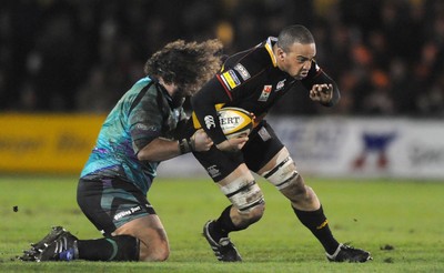 27.03.10 - Newport-Gwent Dragons v Ospreys - Magners League - Gavin Thomas of Newport-Gwent Dragons is tackled by Adam Jones of Ospreys. 