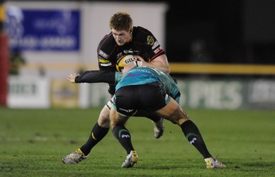 27.03.10 - Newport-Gwent Dragons v Ospreys - Magners League - Andrew Coombs of Newport-Gwent Dragons is tackled by James Hook of Ospreys. 