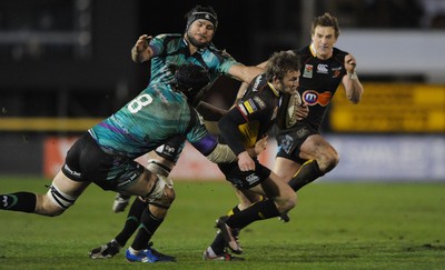 27.03.10 - Newport-Gwent Dragons v Ospreys - Magners League - Martyn Thomas of Newport-Gwent Dragons is tackled by Ryan Jones and Marty Holah of Ospreys. 