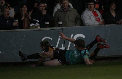 27.03.10 Dragons v Ospreys... Dragons' Will Harries scores try despite tackle by Dan Biggar 