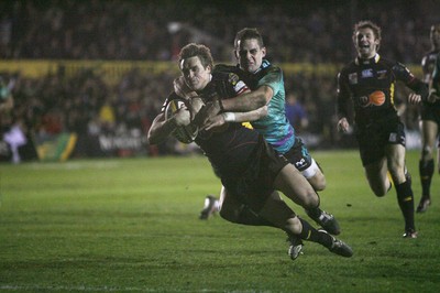 27.03.10 Dragons v Ospreys... Dragons' Matthew Watkins scores try despite tackle by Lee Byrne. 