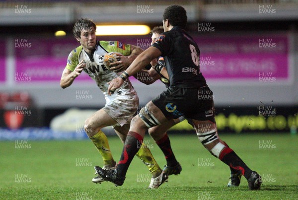 311212 - Newport Gwent Dragons v Ospreys, RaboDirect PRO12 -Ospreys Andrew Bishop takes on Dragons Toby Faletau and Dragons Lewis Robling   