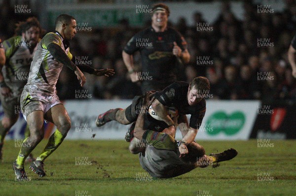 311212 - Newport Gwent Dragons v Ospreys, RaboDirect PRO12 -Dragons Jonathan Evans is tackled by Ospreys Dan Biggar