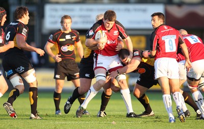 22.08.08...Newport Gwent Dragons v Saracens, pre-season friendly Former Dragons captain, Saracens Michael Owen, is wrapped up by the Dragons defence 