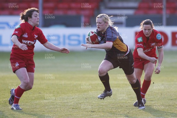 12.05.10 Dragons v Scarlets - WRU Women's Regional  Championship - Dragons' Kim Boaler escapes Scarlets' Caryl James(R) as Elin Evans closes in.  