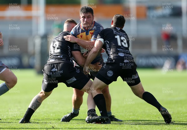 140919 - Dragons v Scarlets - Pre Season Friendly - Marc Jones of Scarlets is tackled by Steff Hughes and Corey Baldwin of Scarlets
