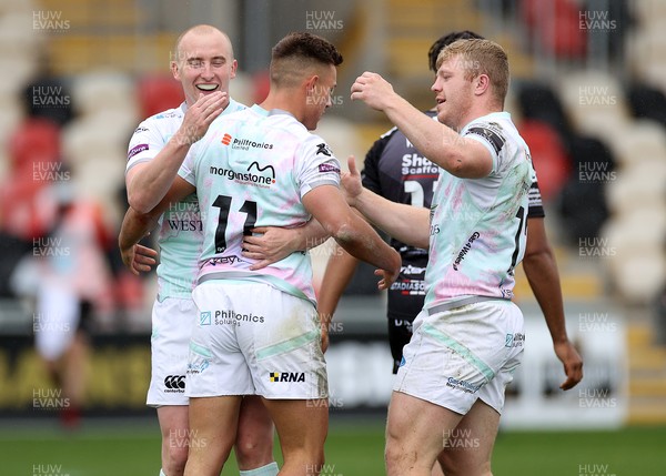 160521 - Dragons v Ospreys - Guinness PRO14 Rainbow Cup - Dewi Cross of Ospreys celebrates scoring a try with Luke Price and Keiran Williams of Ospreys