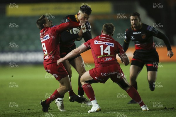 171117 - Dragons v Scarlets, Anglo-Welsh Cup - Jared Rosser of Dragons takes on Lee Rees of Scarlets and Morgan Griffiths of Scarlets