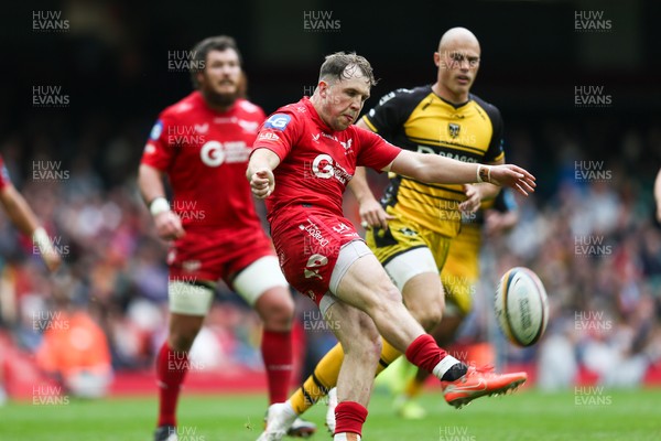 190425 - Dragons RFC v Scarlets - United Rugby Championship - Ioan Lloyd of Scarlets kicks the ball