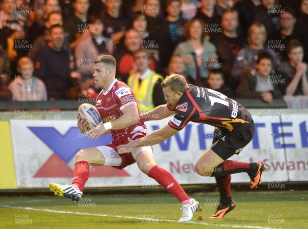 200913 - Newport Gwent Dragons v Scarlets - Rabo Pro Direct 12 - Gareth Davies of Scarlets is tackled by Tom Prydie of Dragons( c ) Huw Evans Agency