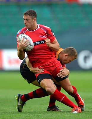 210815 - Newport-Gwent Dragons v Scarlets - Preseason Friendly -Steven Shingler of Scarlets is tackled by Tom Prydie of Dragons