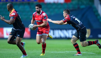 210815 - Newport-Gwent Dragons v Scarlets - Preseason Friendly -Gareth Owen of Scarlets gets past Adam Warren of Dragons