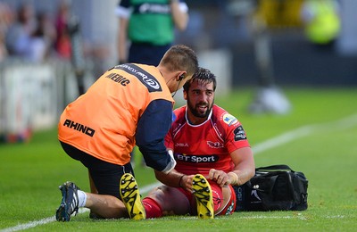 210815 - Newport-Gwent Dragons v Scarlets - Preseason Friendly -Gareth Owen of Scarlets is treated for injury