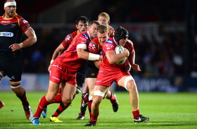 210815 - Newport-Gwent Dragons v Scarlets - Preseason Friendly -James Davies of Scarlets is tackled by Jack Dixon of Dragons