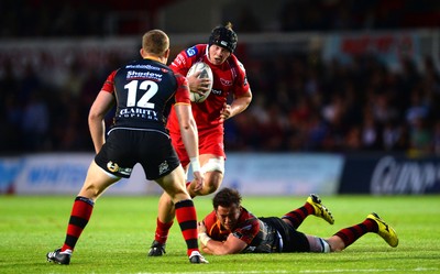 210815 - Newport-Gwent Dragons v Scarlets - Preseason Friendly -James Davies of Scarlets is tackled by James Benjamin of Dragons