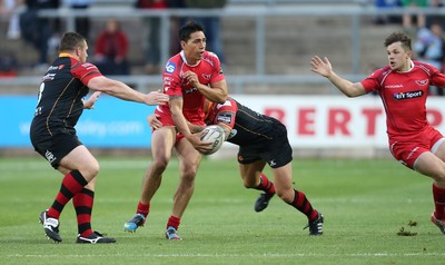 210815 - Newport Gwent Dragons v Scarlets, Pre-Season Friendly match - Scarlets Regan King looks to off load as Ross Wardle tackles