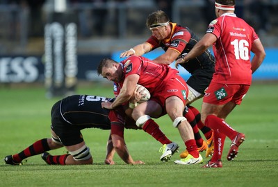 210815 - Newport Gwent Dragons v Scarlets, Pre-Season Friendly match - Scarlets Morgan Allen is tackled by Joe Davies