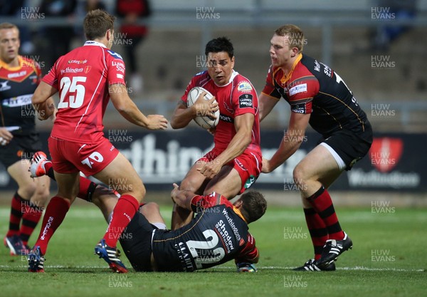 210815 - Newport Gwent Dragons v Scarlets, Pre-Season Friendly match - Scarlets Regan King is tackled by Jason Tovey