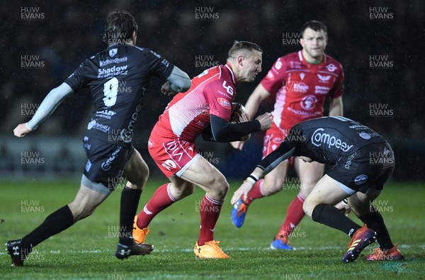 211219 - Dragons v Scarlets - Guinness PRO14 - Hadleigh Parkes of Scarlets is tackled by Sam Davies of Dragons