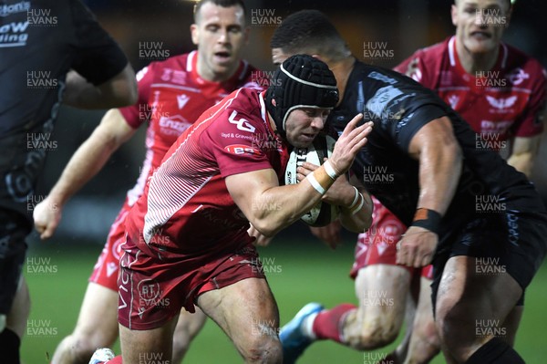 211219 - Dragons v Scarlets - Guinness PRO14 - Leigh Halfpenny of Scarlets is tackled by Leon Brown of Dragons