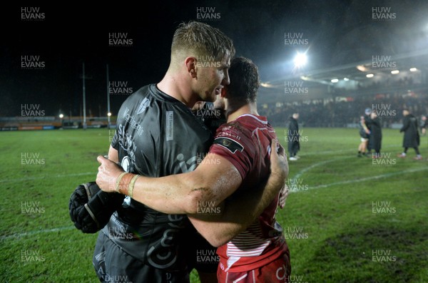 211219 - Dragons v Scarlets - Guinness PRO14 - Aaron Wainwright of Dragons and Leigh Halfpenny of Scarlets at the end of the game