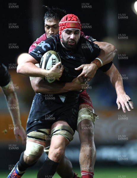 211219 - Dragons v Scarlets - Guinness PRO14 - Cory Hill of Dragons is tackled by Sam Lousi of Scarlets