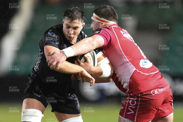 211219 - Dragons v Scarlets - Guinness Pro 14 - Taine Basham of Dragons is tackled by Wyn Jones of Scarlets