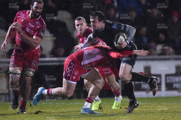 211219 - Dragons v Scarlets - Guinness Pro 14 - Rhodri Williams of Dragons is tackled by Steff Evans of Scarlets