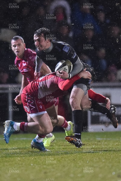 211219 - Dragons v Scarlets - Guinness Pro 14 - Rhodri Williams of Dragons is tackled by Steff Evans of Scarlets