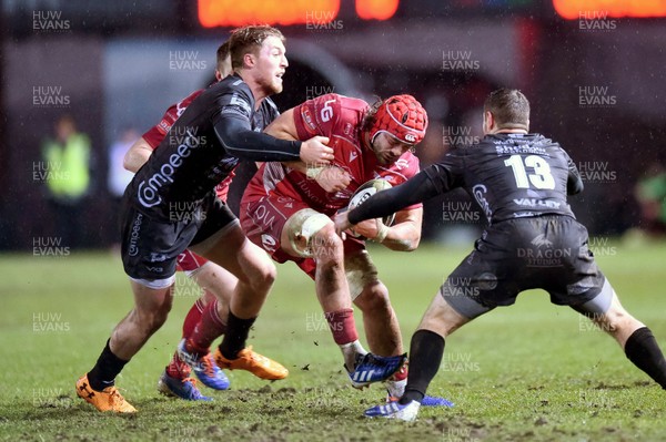 211219 - Dragons v Scarlets - Guinness Pro 14 - Josh Macloed of Scarlets is tackled by Tyler Morgan of Dragons