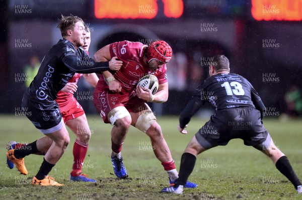 211219 - Dragons v Scarlets - Guinness Pro 14 - Josh Macloed of Scarlets is tackled by Tyler Morgan of Dragons