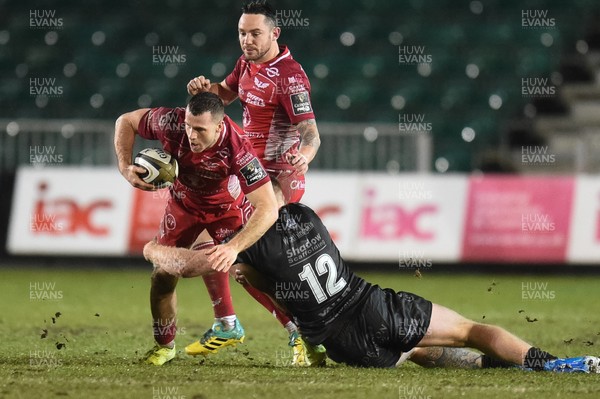 211219 - Dragons v Scarlets - Guinness Pro 14 - Gareth Davies of Scarlets is tackled by Jack Dixon of Dragons