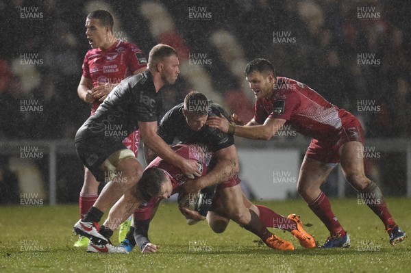 211219 - Dragons v Scarlets - Guinness Pro 14 - Steff Hughes of Scarlets is tackled by Jack Dixon and Ross Moriarty of Dragons