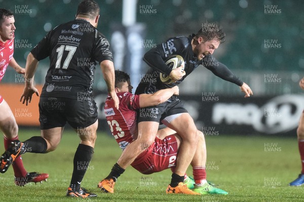 211219 - Dragons v Scarlets - Guinness Pro 14 - Tyler Morgan of Dragons is tackled by Corey Baldwin of Scarlets