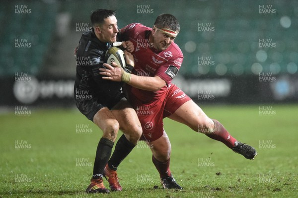 211219 - Dragons v Scarlets - Guinness Pro 14 - Sam Davies of Dragons is tackled by Wyn Jones of Scarlets