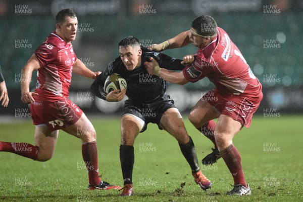 211219 - Dragons v Scarlets - Guinness Pro 14 - Sam Davies of Dragons is tackled by Wyn Jones of Scarlets
