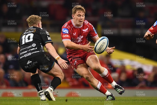 220423 - Dragons v Scarlets - United Rugby Championship - Sam Costelow of Scarlets gets the ball away