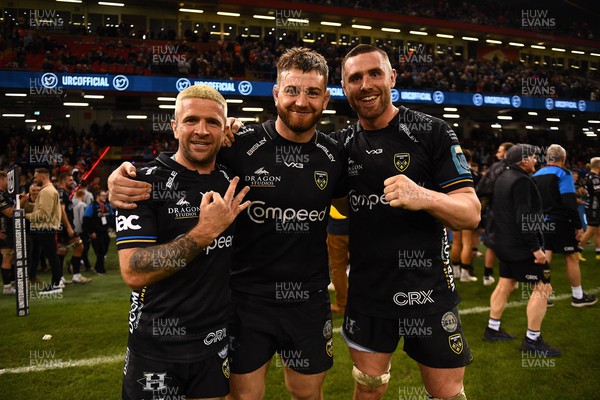220423 - Dragons v Scarlets - United Rugby Championship - Lewis Jones, Rhodri Jones and George Nott of Dragons celebrate at the end of the game