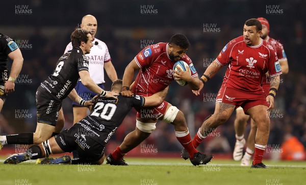220423 - Dragons v Scarlets - United Rugby Championship - Judgement Day - Carwyn Tuipulotu of Scarlets is tackled by Sean Lonsdale of Dragons 