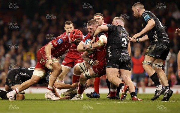 220423 - Dragons v Scarlets - United Rugby Championship - Judgement Day - Iwan Shenton of Scarlets is tackled by Lloyd Fairbrother of Dragons 