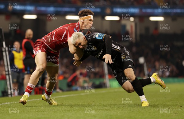 220423 - Dragons v Scarlets - United Rugby Championship - Judgement Day - Tom Rogers of Scarlets is tackled by Jordan Williams of Dragons 