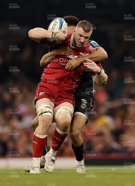 220423 - Dragons v Scarlets - United Rugby Championship - Judgement Day - Morgan Jones of Scarlets is tackled by Rio Dyer of Dragons 