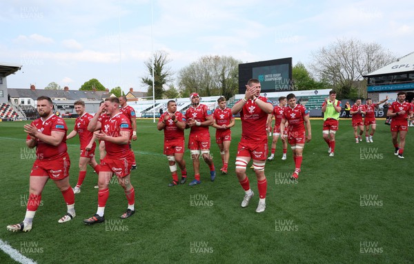 230422 - Dragons v Scarlets, United Rugby Championship - Scarlets players applaud the travelling fans at the end of the match