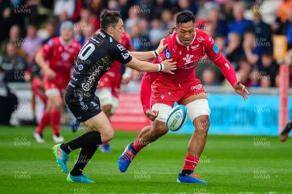 230422 - Dragons v Scarlets - United Rugby Championship - Sam Lousi of Scarlets  is tackled by Sam Davies of Dragons